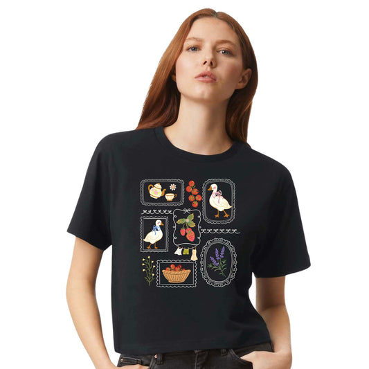 Black cottagecore goose women's crop tee with floral and strawberry illustrations