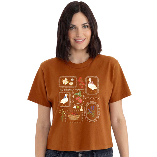 Rust cottagecore goose women's crop tee with strawberries and vintage botanical frames