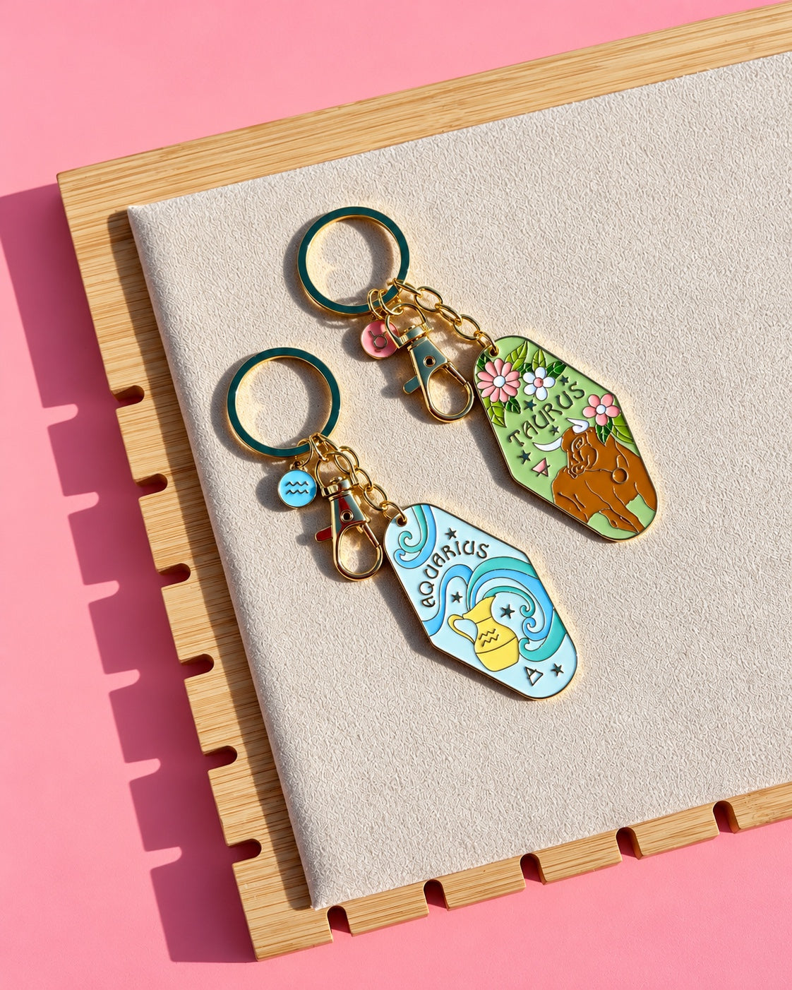 Gold zodiac keychains Aquarius and Taurus