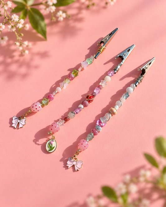 Three handmade strawberry and bow beaded roach clip designs