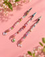 Three handmade strawberry and bow beaded roach clip designs